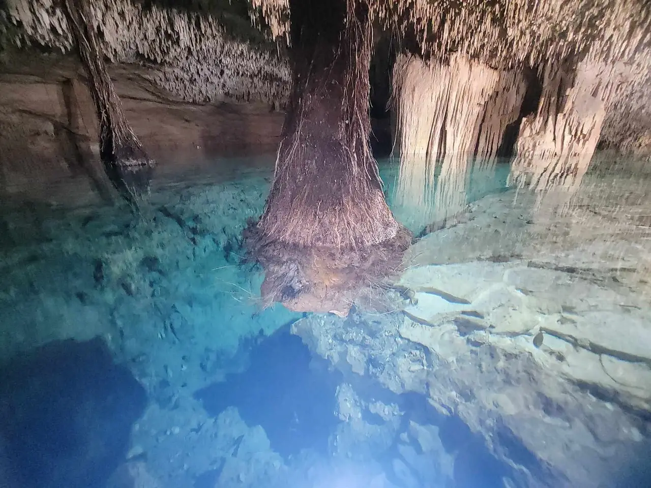 Rock walls and water inside Kin-Ha cenote